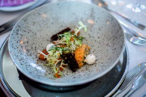 Assiette comportant des mets raffinés dignes d'un restaurant étoilé.