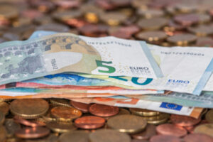 Euros éparpillés en pièces de monnaie et en billets.